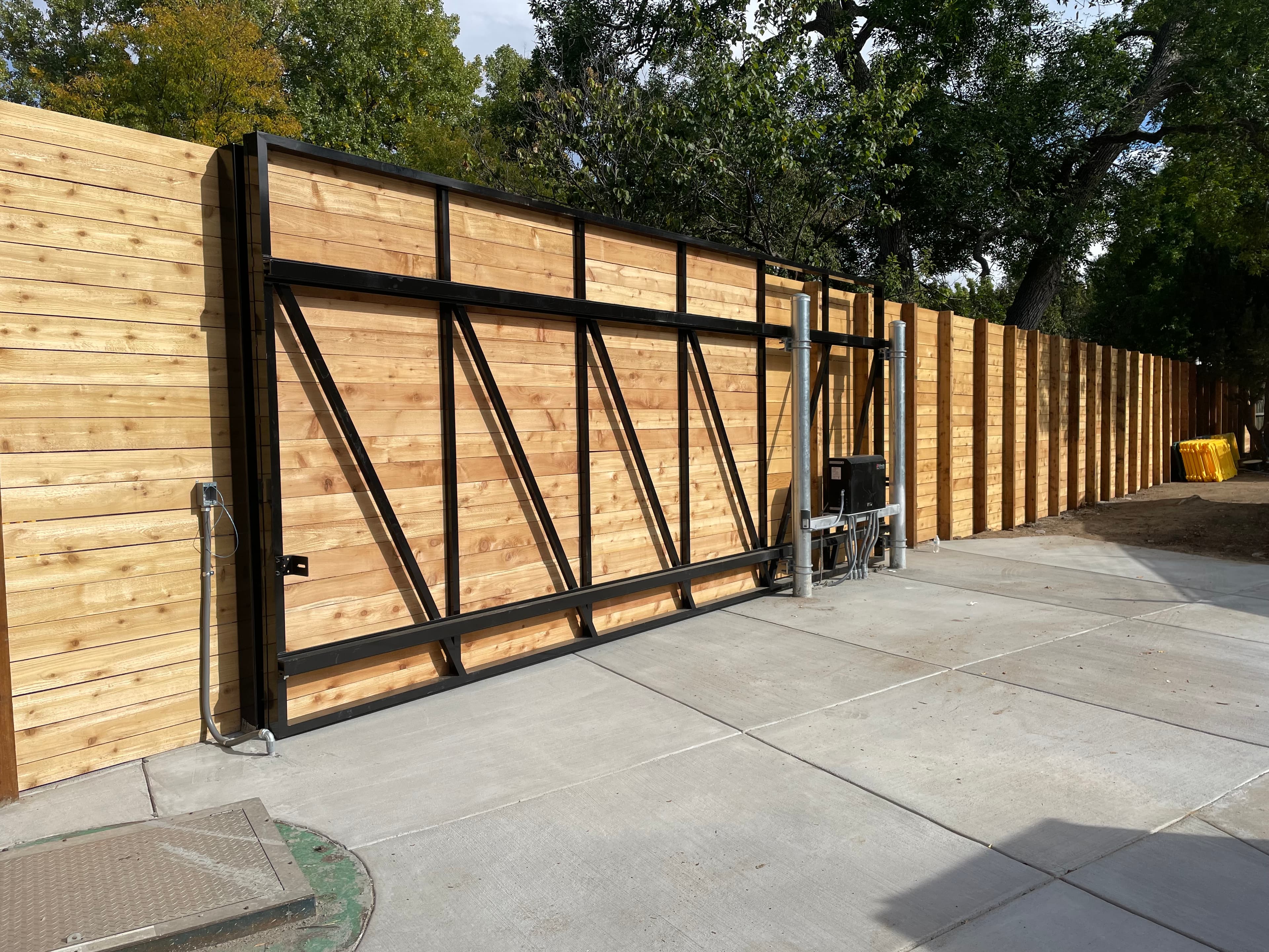 Aluminum cantilever slide gate with cedar infill and HySecurity HD25 operator with photo eye and loops