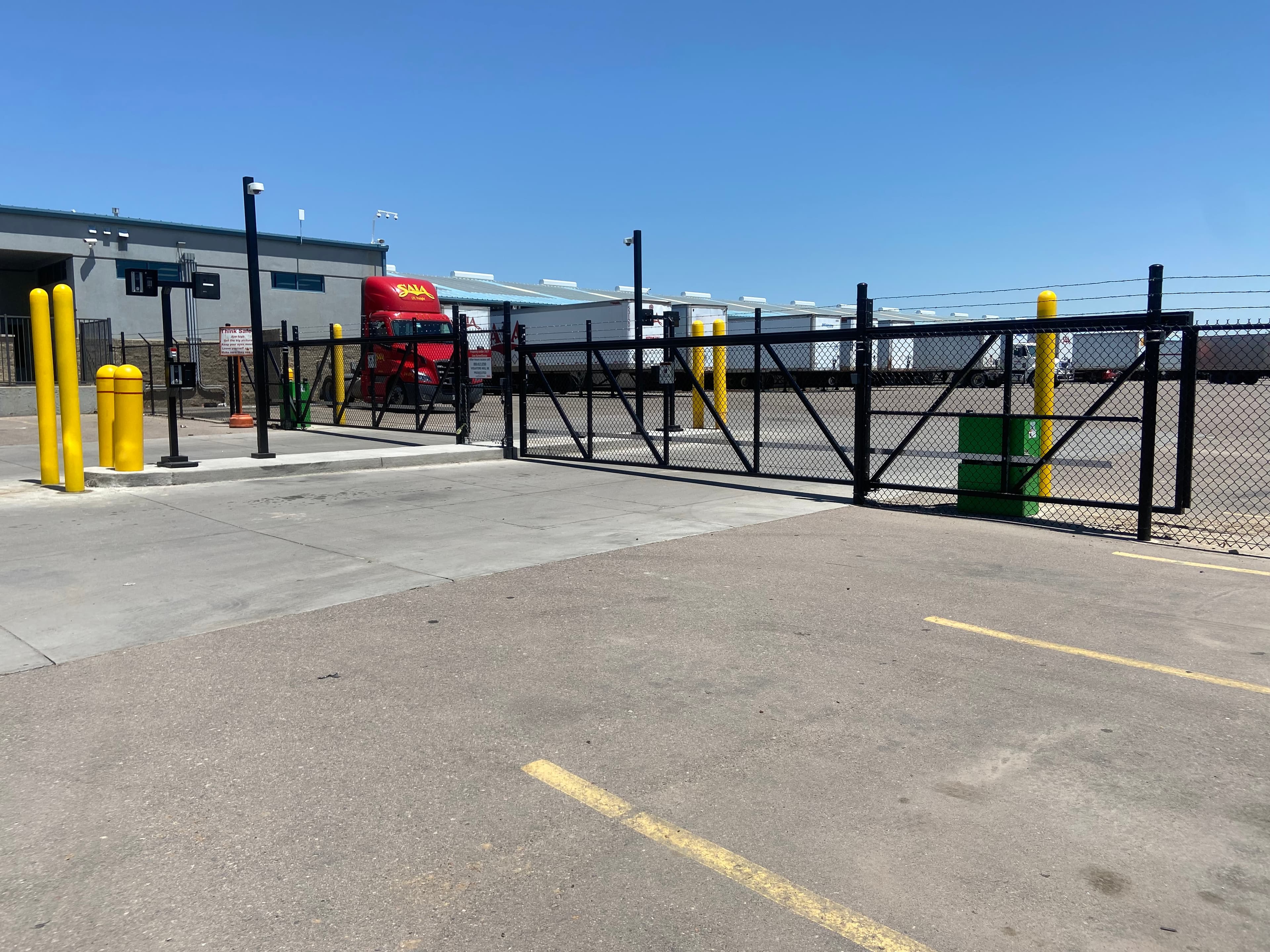 Entry/Exit aluminum cantilever slide gates with industrial hydraulic HySecurity operators, video call access and CCTV in Henderson, CO