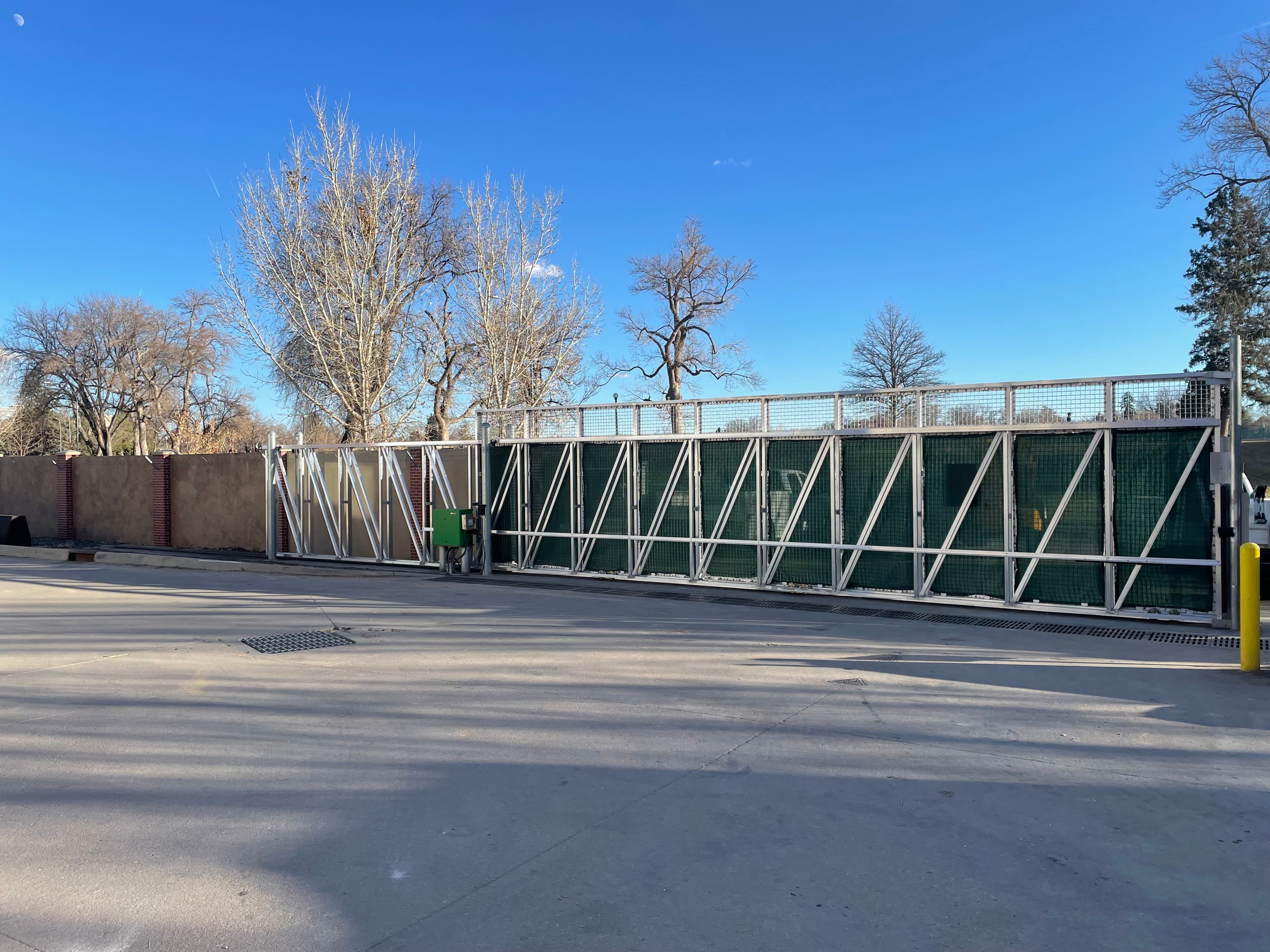 Industrial aluminum slide gate with privacy screen and hydraulic operator in Denver, CO